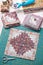 Patchwork log cabin blocks on craft mat, stack of blocks, sewing accessories