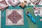 Patchwork log cabin blocks on craft mat, stack of blocks, sewing accessories