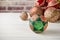 Patchwork puzzle balls and christmas decorations in basket on brick wall background