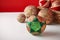 Patchwork puzzle balls and christmas decorations in basket on white and red background