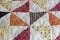 A patchwork quilt or bedspread.A fragment of a patchwork quilt as a background. Colored patchwork quilt. Colored blanket