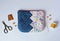 Patchwork zipper pouch with hand stitches, thread, scissors, thimble, needle and buttons