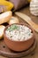 Pate of smoked fish with sour cream and greens on a wooden board