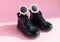 Patent children`s boots shoes and accessories for little fashionistas on a pink background