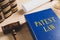 Patent Law book and gavel on wooden table