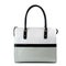 Patent leather handbag with black handles isolated on white.