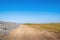 Path across Northam Burrows reserve and SSSI, with grass, sand and pebbles. Scenic north Devon, UK