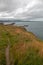 Path along knoll above Wicklow Ireland North Harbor Breakwater Wall and Lighthouse