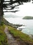 Path along rocky ocean shore with mist