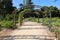 A path of black rod iron arches covered with flowers in the garden