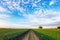 Path in countryside with green field