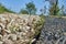 Path delimitation made of pebbles as a drain for rainwater next to a footpath in nature