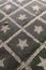 Path in the garden, made of black and white stones in cement with fallen leaves texture background