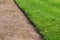 A path of gravel and a lawn of clipped green grass in the Gatchina Park.