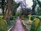 Path through High Gate Cemetery East with gravestones and green plants