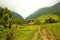 Path and home in the Cocora Valley with wax palm, between the mo