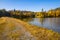 Path, lake and colorful trees in autumn landscape