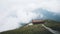 Path leading to house overlooking mountains covered by clouds on Wugong Mountain in Jiangxi, China