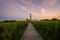 Path leading toward Bodie Island Lighthouse at dusk