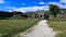 Path leading towards stone ruins with green mountains during a sunny weather. Gjirocaster castle, Albania