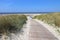A path made of wood leads to the sandy beach on the North Sea island of Langeoog