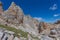 Path in the middle of dolomite rocky scenario in the Latemar Massif, Italy