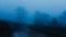 A path through moorland on a moody, dark, foggy, winters evening. With a blue hour edit