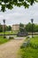 Path to monument of old cannon firing nuclei in a flowering city park