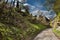 Path to wooden cottages in sunny spring afternoon in village Karba in spring czech tourist area Machuv kraj