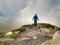 Path on top of Diamond hill male tourist walking, Connemara National park, county Galway Ireland. Cloudy sky