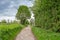 Path through traditional English countryside under gloomy threatening clouds, Cheshire, UK