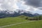 Path with Utah Snow capped mountains with rolling green hills