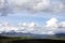 Path with Utah Snow capped mountains with rolling green hills