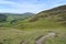 Path winding on hillside with fields below