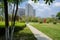 Paths in grassy lawn before multi-storied apartment in sunny su