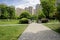 Paths in lawn before storied apartments at sunny summer noon