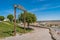 Pathway in the castle with a swinging wood structure with a phrase alluding to Alcacér do Sal, PORTUGAL