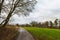 pathway into the forrest passing fields and meaows