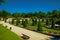 Pathway on gardens with trees and benches in a park of Madrid