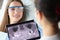 Patient on dental consultation in clinic, doctor examine teeth x ray on digital tablet device