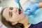 Patient in dentistry with stomatological tools, closeup