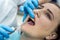 Patient in dentistry with stomatological tools, closeup