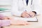 Patient listening intently to a male doctor explaining patient symptoms or asking a question as they discuss paperwork together