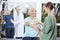 Patient Looking At Nurse Putting Crepe Bandage On Hand