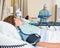 Patient\'s Lying On Bed While Nurse Examins Report