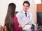 Patient and therapeutist at desk in clinic