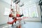 Patient training on suspension trainer with help of physical therapist