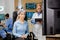 Patient woman with scanning device on her head and doctor scheduling it with tablet in hand