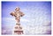 Patiently building of faith - Celtic carved stone cross against a sky background - concept image in puzzle shape