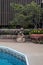 Patio planter filled with colorful little flowers by a swimming pool